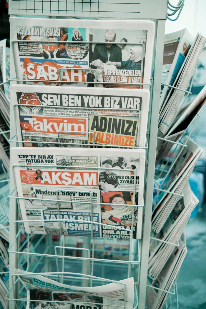 Close-up of a rack with Turkish newspapers, showcasing headlines in vibrant colors.